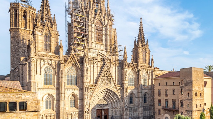 Cathedral of Barcelona with visitors in the plaza, showcasing Gothic architecture.