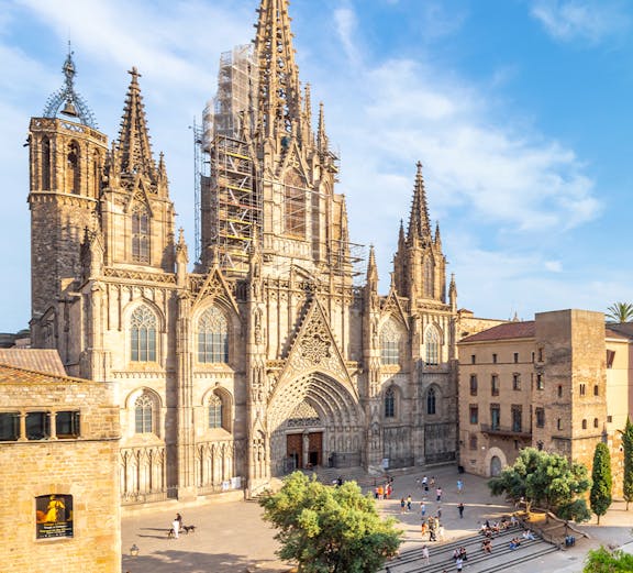 Cathedral of Barcelona with visitors in the plaza, showcasing Gothic architecture.