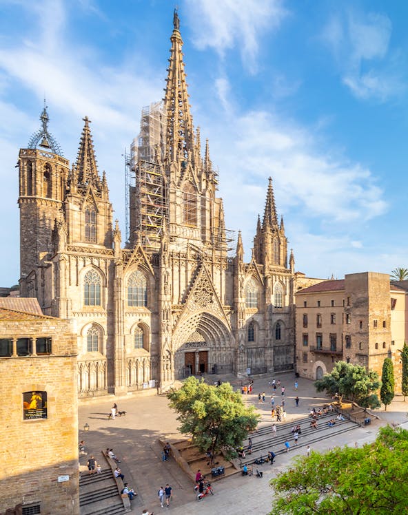 Cathedral of Barcelona with visitors in the plaza, showcasing Gothic architecture.