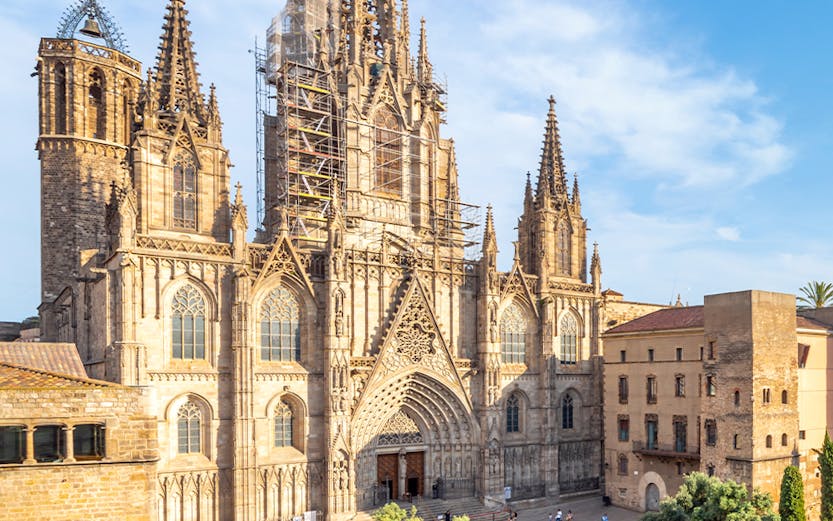 Cathedral of Barcelona with visitors in the plaza, showcasing Gothic architecture.