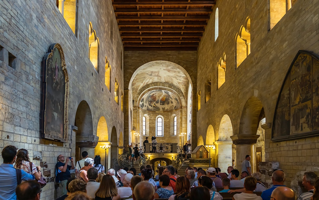 Tourists inside a historic hall at Prague Castle, Czech Republic.