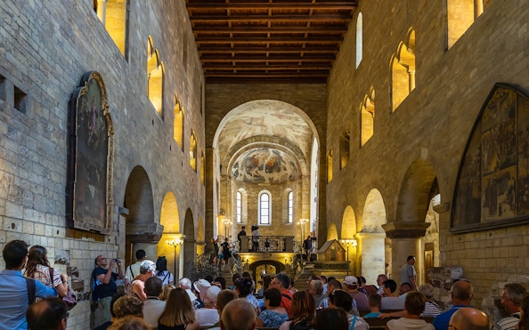 Tourists inside a historic hall at Prague Castle, Czech Republic.