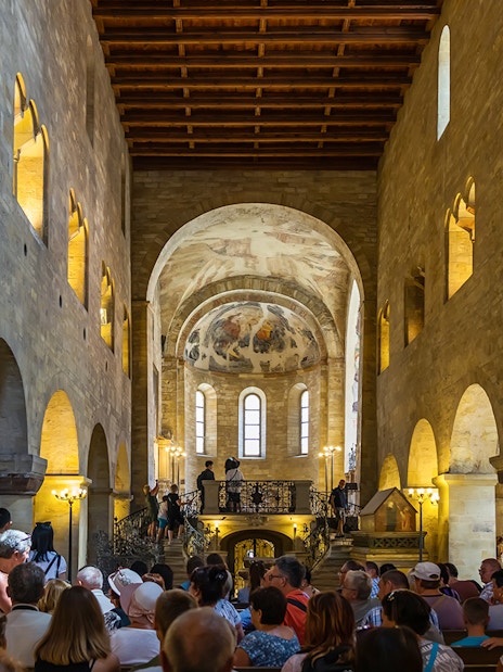 Tourists inside a historic hall at Prague Castle, Czech Republic.