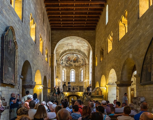 Tourists inside a historic hall at Prague Castle, Czech Republic.