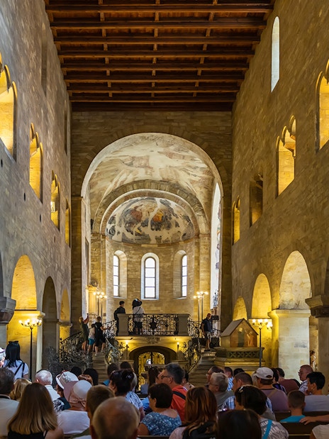 Tourists inside a historic hall at Prague Castle, Czech Republic.
