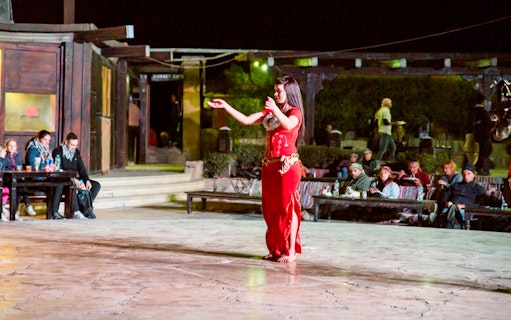 Belly dancer performing at a Hurghada desert camp during a quad bike safari tour.
