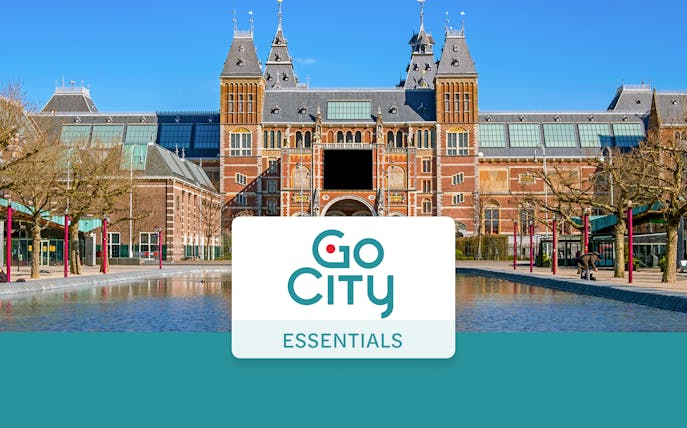 Rijksmuseum facade in Amsterdam with Go City Essentials Pass logo.