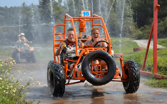 Participants driving through water on Alanya Buggy Safari tour.