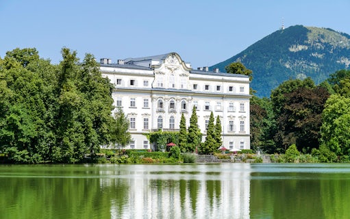 Leopoldskron Palace with lake and mountain backdrop, Salzburg, Austria.