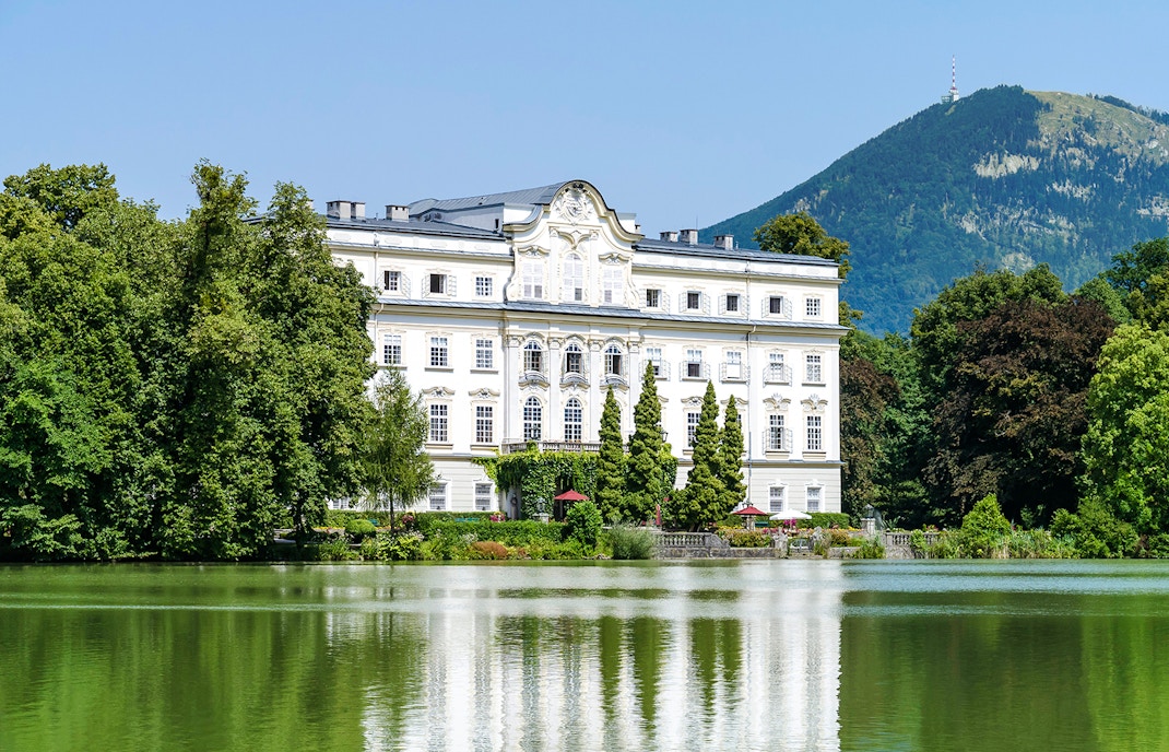 Leopoldskron Palace with lake and mountain backdrop, Salzburg, Austria.