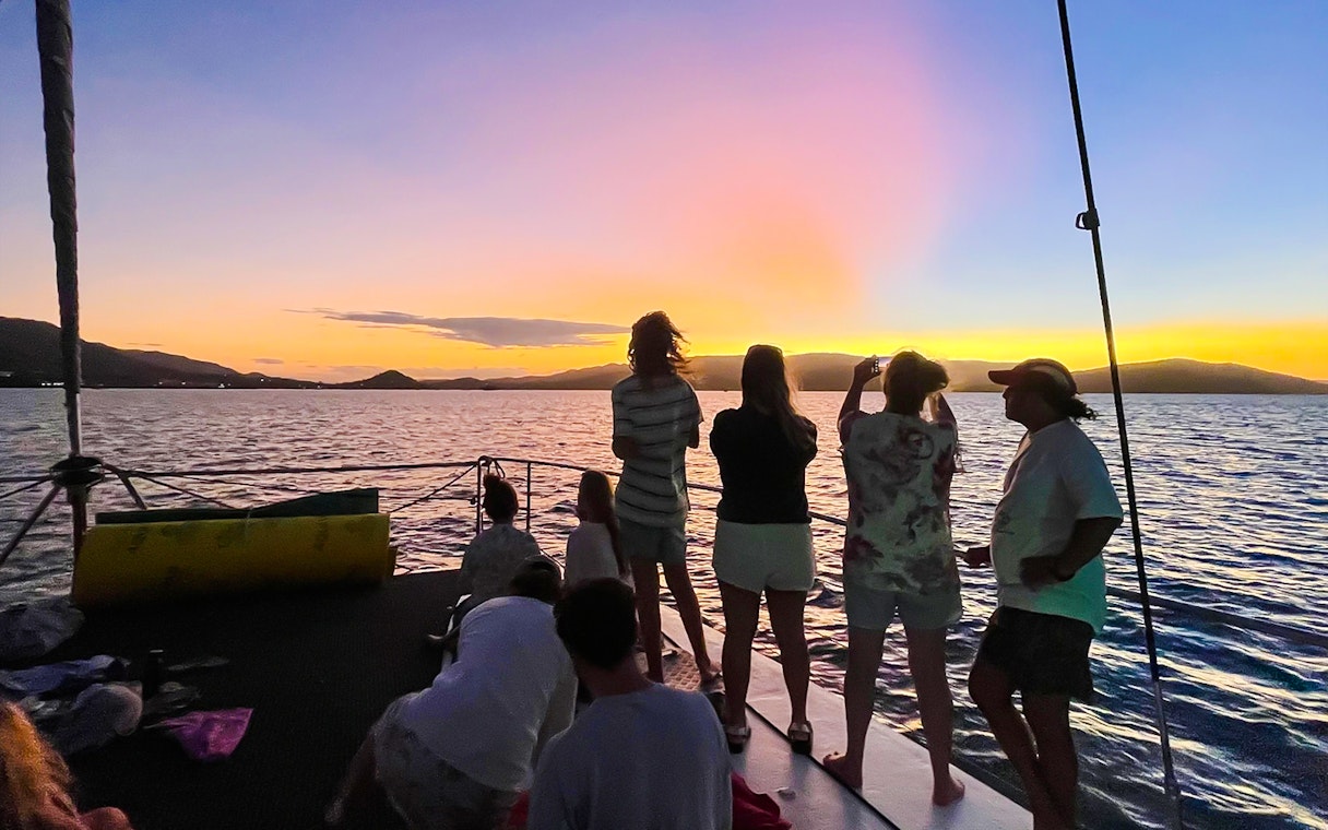 Tourists enjoying a sunset sail in the Whitsundays, Australia.