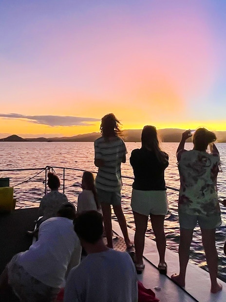 Tourists enjoying a sunset sail in the Whitsundays, Australia.