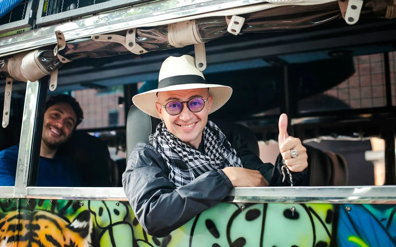 Guests enjoying a colorful bus ride on the Guatapé Adventure tour.
