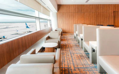 Plaza Premium Lounge seating area with airport runway view, Terminal 3, Toronto Pearson International Airport.