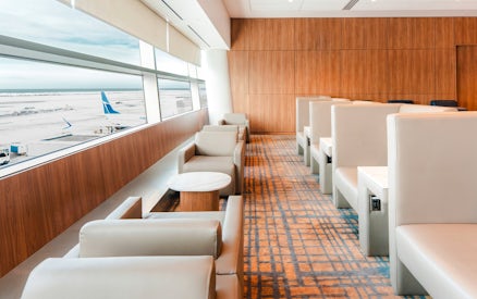 Plaza Premium Lounge seating area with airport runway view, Terminal 3, Toronto Pearson International Airport.