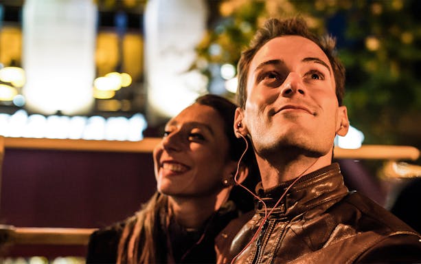 Man enjoying audio guide on Dublin night tour.