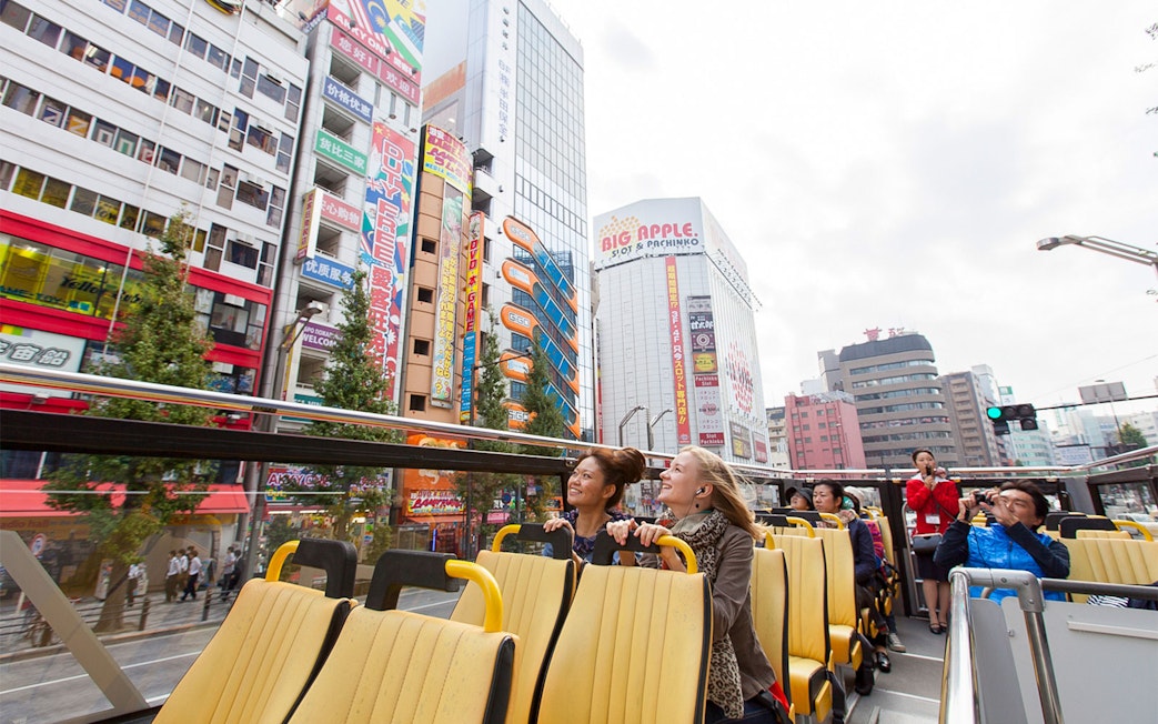 Tokyo hop-on hop-off bus tour with passengers enjoying city views.