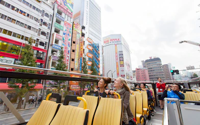 Tokyo hop-on hop-off bus tour with passengers enjoying city views.