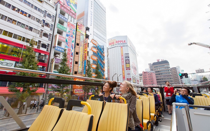 Tokyo hop-on hop-off bus tour with passengers enjoying city views.