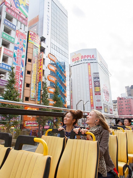 Tokyo hop-on hop-off bus tour with passengers enjoying city views.