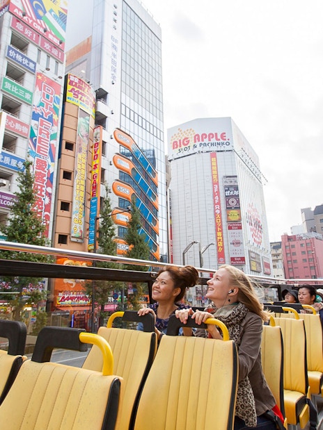 Tokyo hop-on hop-off bus tour with passengers enjoying city views.