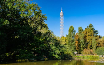Torre Branca rising above lush trees in Milan's Sempione Park.