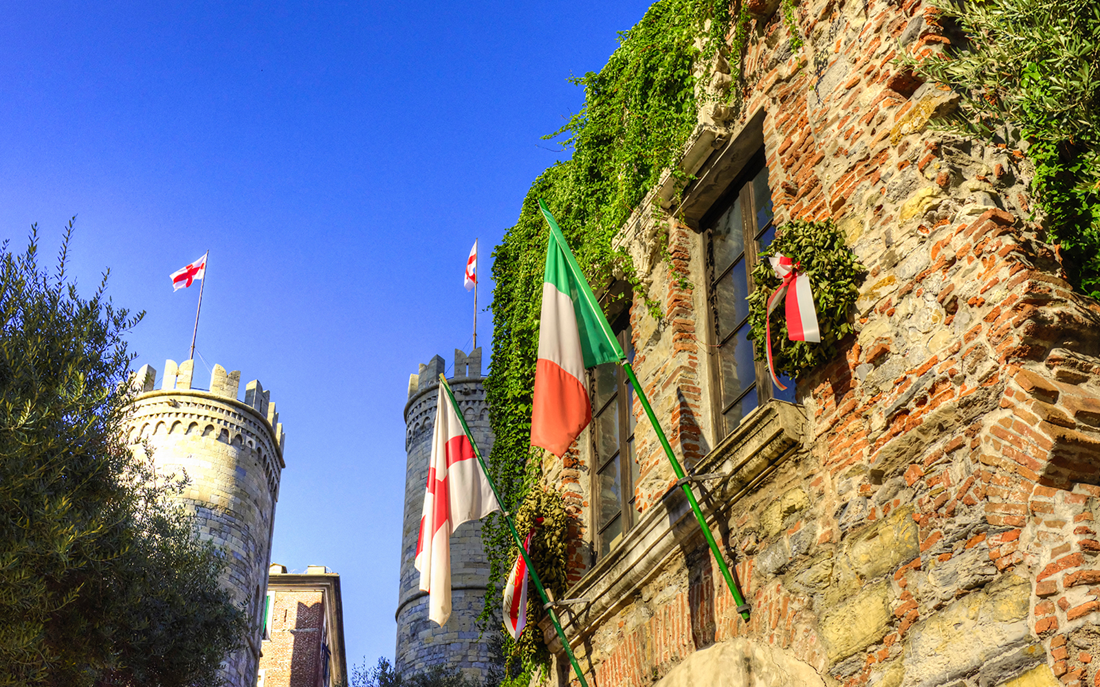 Casa di Colombo with Italian and Genoese flags, Genoa, Italy.