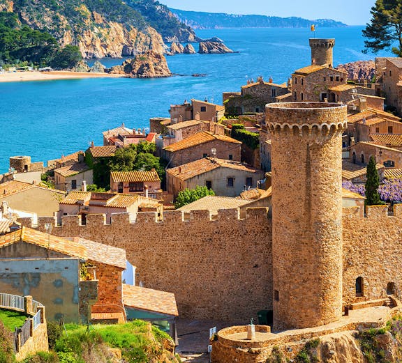 Tossa de Mar Old Town walls overlooking sand beach and sea, Catalonia, Spain.