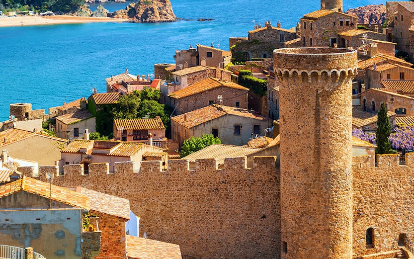 Tossa de Mar Old Town walls overlooking sand beach and sea, Catalonia, Spain.