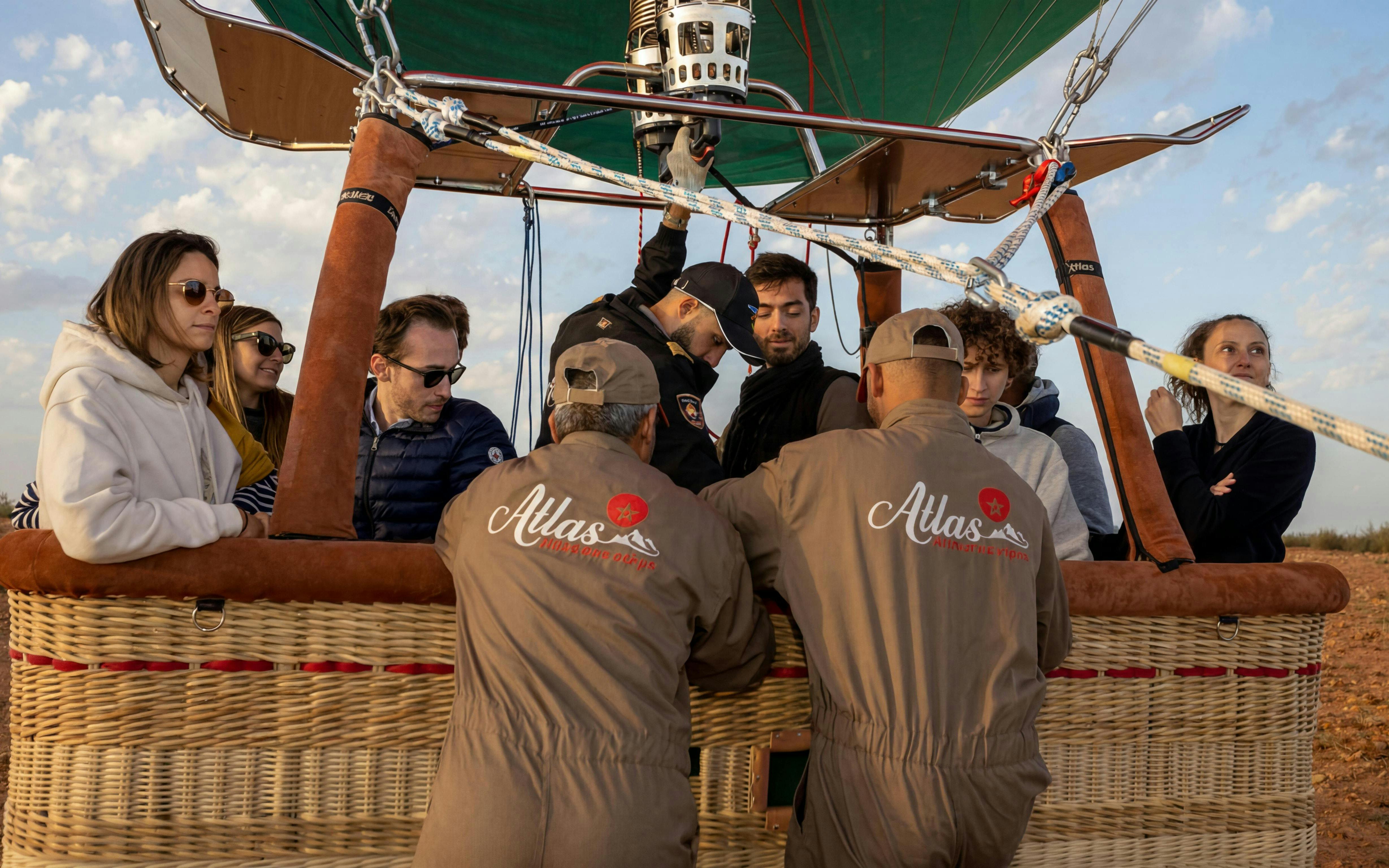 Hot air balloon passengers prepare for sunrise flight in Marrakesh.