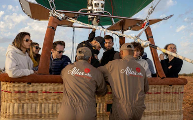 Hot air balloon passengers prepare for sunrise flight in Marrakesh.