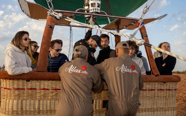 Hot air balloon passengers prepare for sunrise flight in Marrakesh.