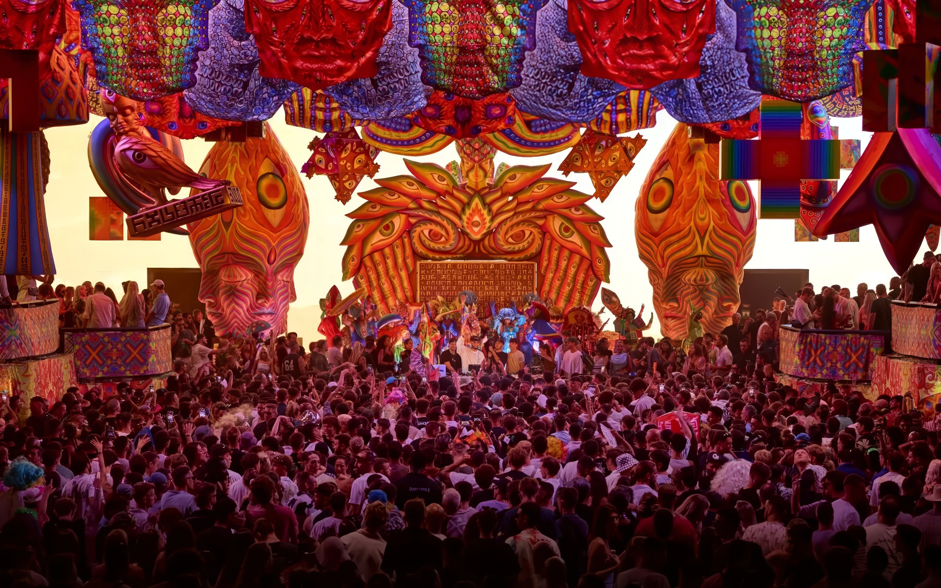 Crowd enjoying vibrant elRow performance with colorful decorations in Ibiza.