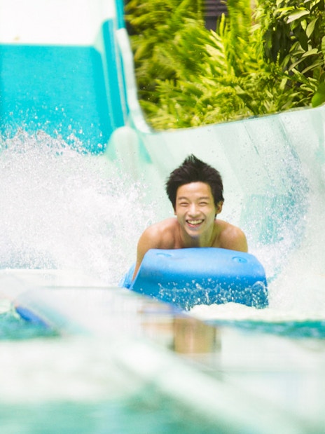 Riders enjoying a water slide at Adventure Cove Waterpark™.