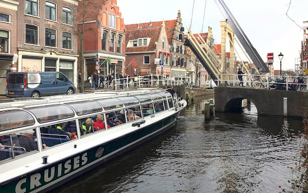 Canal cruise boat passing under a drawbridge in Alkmaar.