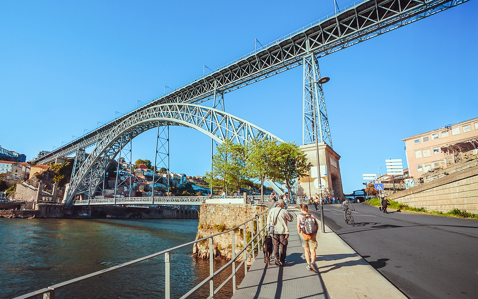 Tourists walking near Ponte D. Luís bridge in Porto.