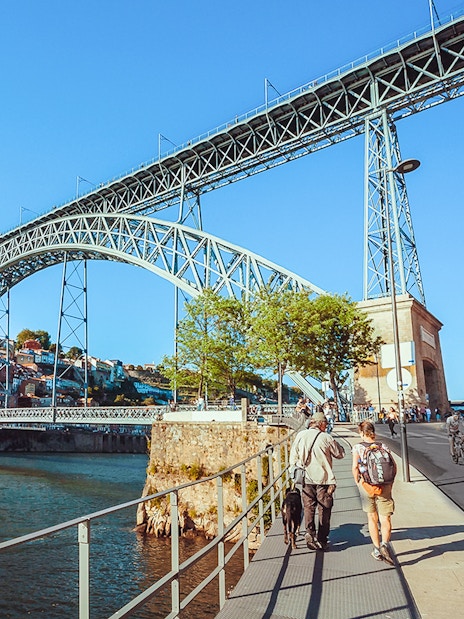 Tourists walking near Ponte D. Luís bridge in Porto.