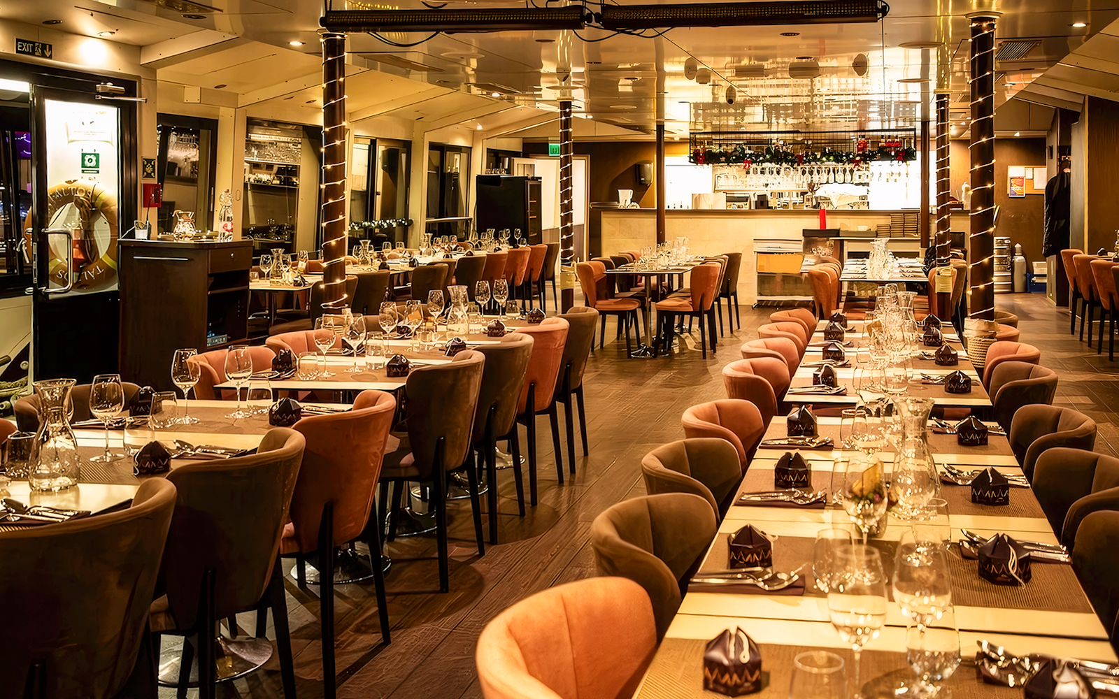 Interior of a Christmas cruise dining area in Budapest with elegantly set tables.