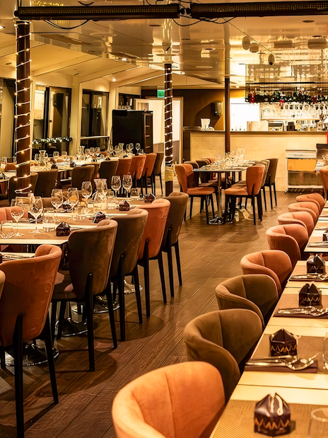 Interior of a Christmas cruise dining area in Budapest with elegantly set tables.