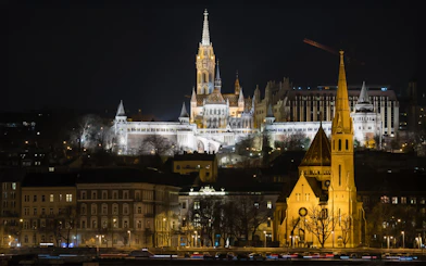 The Church of Our Lady illuminated at night from a Danube sightseeing dinner cruise.