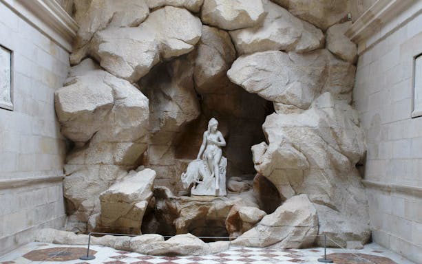 Statue in rocky alcove at The Queen's Dairy, Castle of Rambouillet.