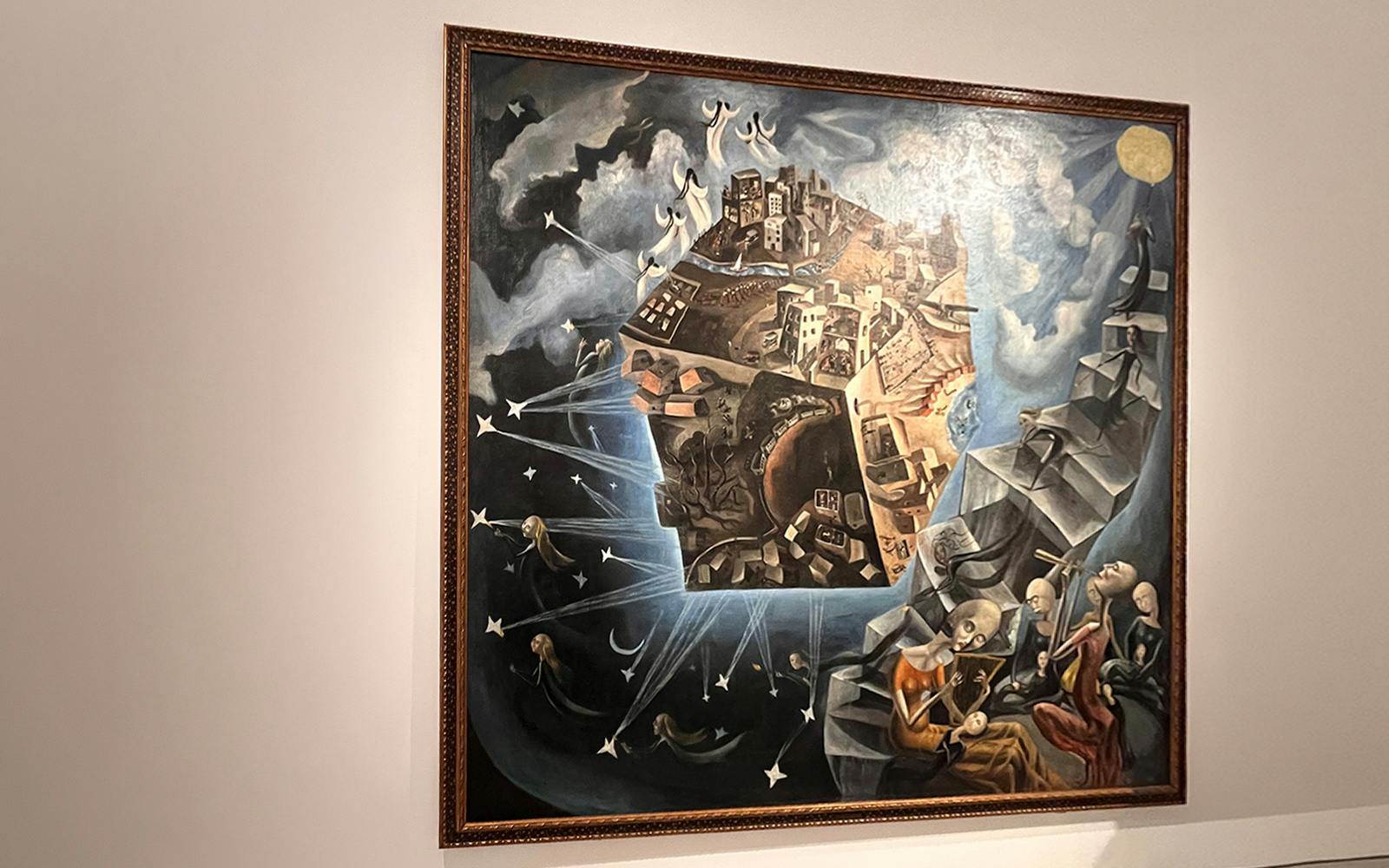 Ángeles Santos’s "A World" painting at Reina Sofia Museum, depicting a surreal cityscape and celestial figures.