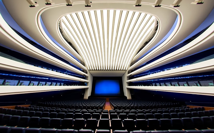 Interior of Palau de les Arts Reina Sofía auditorium, Valencia, with modern seating and architectural design.