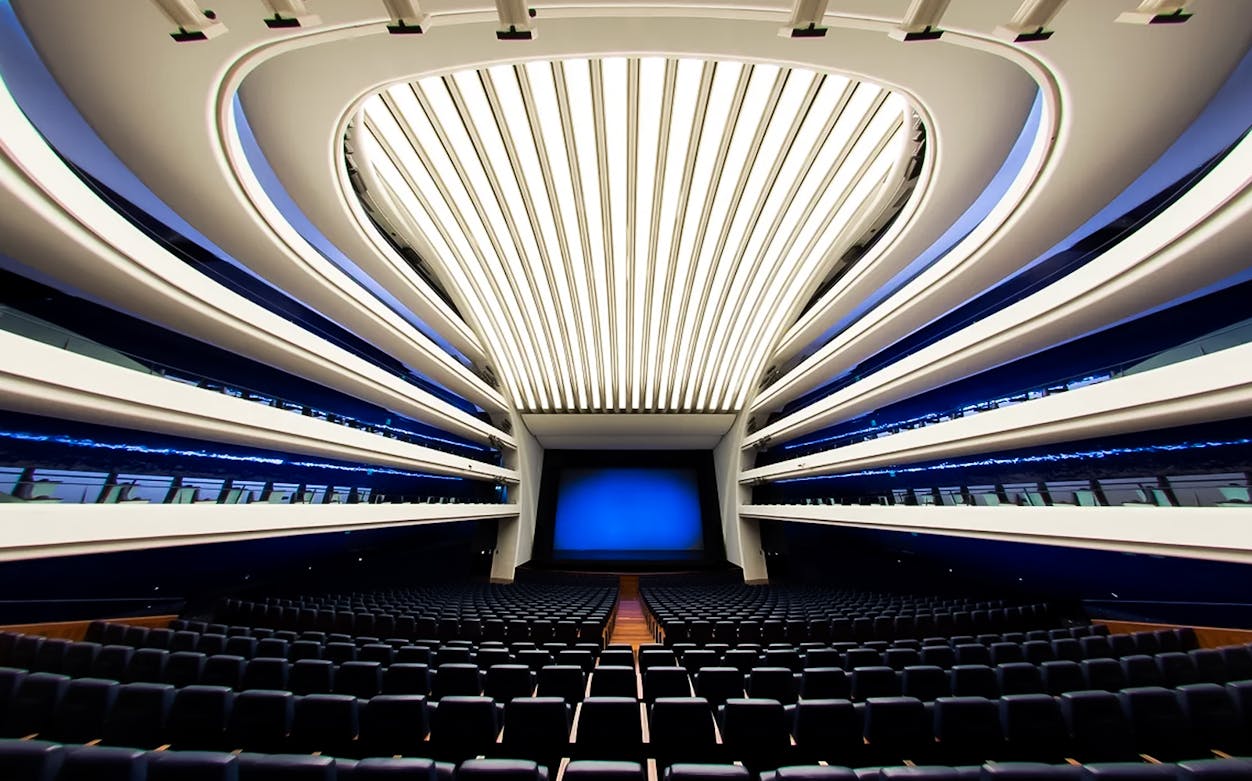 Interior of Palau de les Arts Reina Sofía auditorium, Valencia, with modern seating and architectural design.