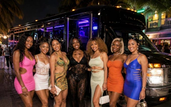 Group enjoying Sint Maarten Party Bus Nightlife Tour with bar stops and complimentary shots.