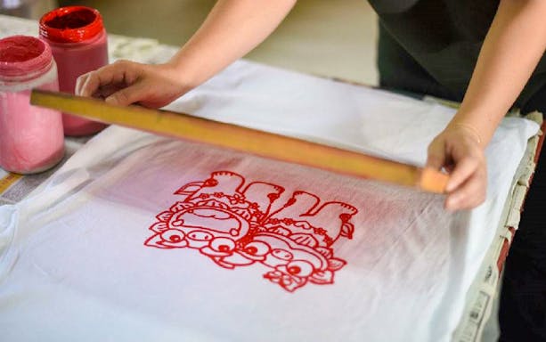 Screen printing traditional design at Murasaki Mura Ryukyu Kingdom Theme Park.