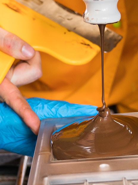 Pouring chocolate into mold during Vienna chocolatier workshop.
