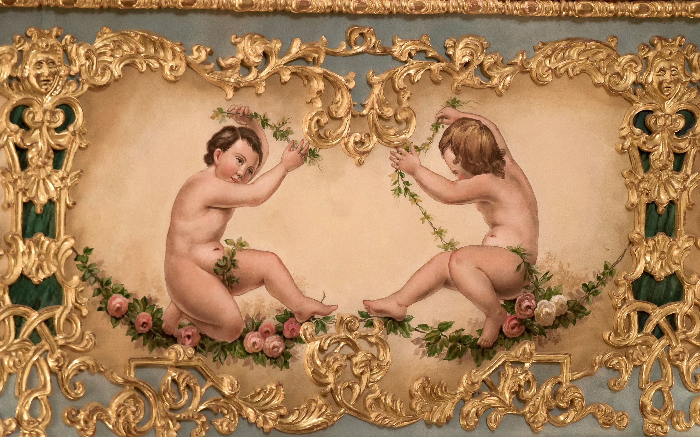 Cherubs with floral garlands in ornate gold frame at Teatro La Fenice, Venice.