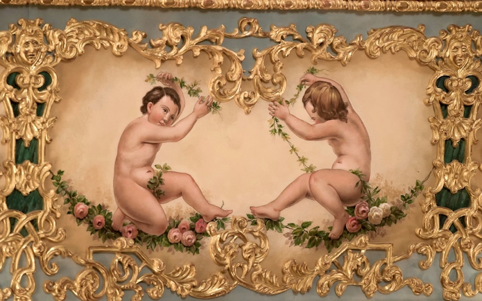 Cherubs with floral garlands in ornate gold frame at Teatro La Fenice, Venice.