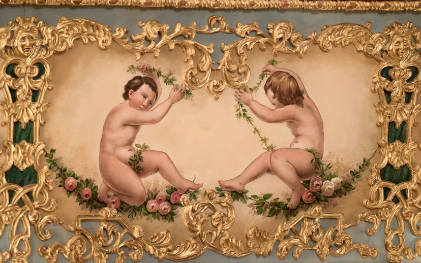 Cherubs with floral garlands in ornate gold frame at Teatro La Fenice, Venice.